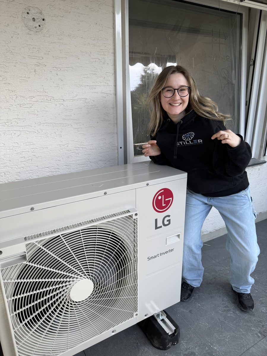 Mitarbeiterin von Stiller Kälte neben einem LG-Außengerät